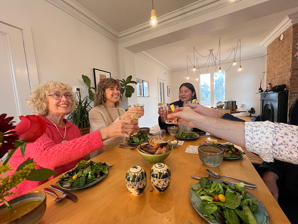 People clinking cheers at table